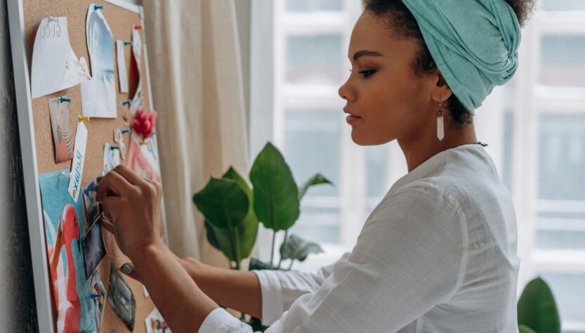 Woman in White Long Sleeve Shirt Holding Pink and White Floral Textile. Goal setting for 2026 on My Jamaican Vignettes