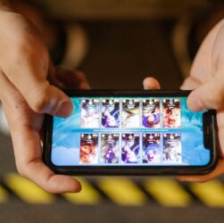 Hands holding a smartphone displaying a mobile game