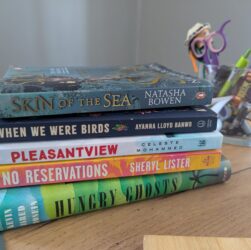 A stack of five fiction books