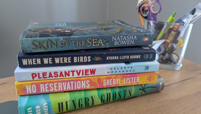 A stack of five fiction books